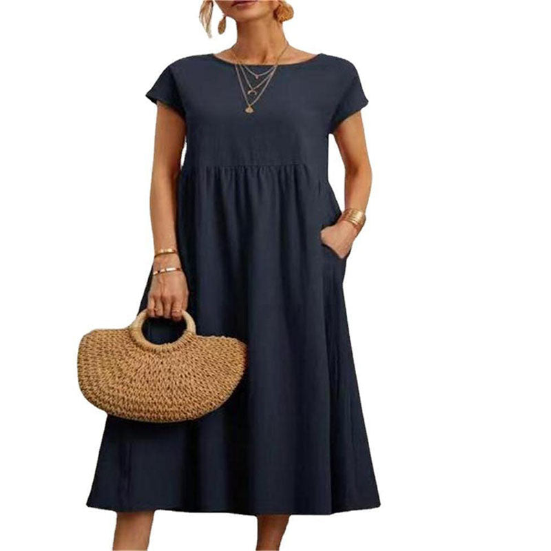 Ensfarget, ermeløs, løs bomullskjole i lin uten lommer